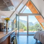 At 400 square feet of polished concrete floor, this triangle-shaped tiny house in Colorado is the perfect unique vacation rental getaway for travelers. The coded door makes it easy for guests to enter and exit as they please.

Colorado's Thimble Rock Point, Cliffs in Unaweep Canyon is visible out the front glass window from the master bedroom.