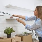 Woman wipes the kitchen after moving to new apartment.