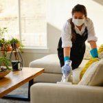 A professional housecleaner at work cleaning a home.